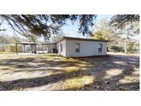 White single story home with covered carport and gazebo in backyard at 17130 Pasco Acres Dr, Spring Hill, FL 34610