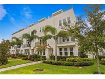 Modern three-story townhome with landscaped grounds at 2442 W Mississippi Ave # 6, Tampa, FL 33629