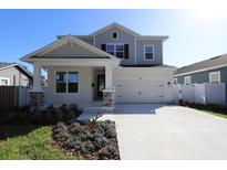 Two-story Craftsman style home with a gray exterior, stone accents, and a two-car garage at 3221 20Th N St, St Petersburg, FL 33713