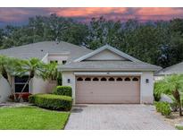Two-story house with attached garage and landscaped yard at 604 Masterpiece Dr # 604, Sun City Center, FL 33573