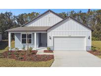One-story house with gray siding, white trim, and a two-car garage at 1285 Kazaz Ct, Zephyrhills, FL 33540