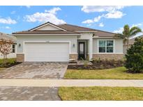 One-story home with a two-car garage and attractive landscaping at 11680 Myakka Blue Dr, Venice, FL 34293