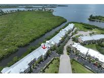 Aerial view of waterfront community with lush landscaping and canal access at 3226 Mangrove Point Dr, Ruskin, FL 33570