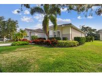 Beautiful single-story home with lush green lawn and vibrant landscaping at 5621 Rock Dove Dr, Sarasota, FL 34241