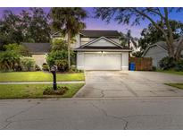 Two-story house with attached garage and manicured lawn at 12415 Pathway Ct, Riverview, FL 33569