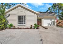 Newly renovated single-story home with landscaped yard and driveway at 13339 Laraway Dr, Riverview, FL 33579