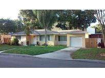 House exterior featuring a well-maintained lawn and a attached garage at 737 13Th N Ave, St Petersburg, FL 33701