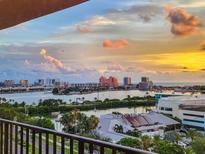 Stunning aerial view showcasing waterfront property, marina, and city skyline at 51 Island Way # 1107, Clearwater Beach, FL 33767