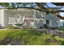 Exterior view of condo building, showing a well-maintained building with landscaping at 12141 Spartan Way # 103, Hudson, FL 34667