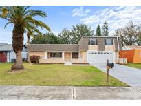 Cute ranch-style home with a well-maintained lawn and attached garage at 3600 Landale Dr, Holiday, FL 34691