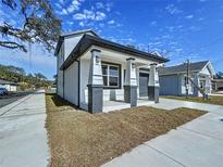 Two-story house with gray accents and a covered porch at 2404 1/2 E Chelsea, Tampa, FL 33610