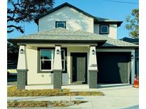 Two-story home with dark gray accents and a gray roof at 2404 E Chelsea, Tampa, FL 33610