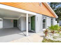 Green front door with a white frame and sidelights at 4607 W San Jose St, Tampa, FL 33629