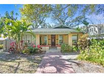 Charming bungalow with landscaped yard and brick pathway at 5700 N Suwanee Ave, Tampa, FL 33604