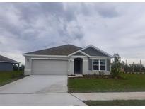 New single-story home with gray siding, two-car garage, and landscaping at 11116 40Th E Ave, Palmetto, FL 34221