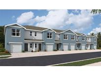 Row of new two-story townhomes with attached garages and modern gray and blue facades at 4215 Red Banks Ln, Bradenton, FL 34208