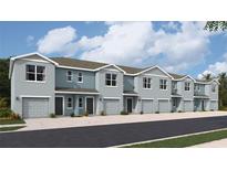 Row of modern townhomes with two-car garages and light blue exteriors at 4309 Red Banks Ln, Bradenton, FL 34208