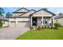 Two-story home with a large front porch and attached garage at 4656 Southern Valley Loop, Brooksville, FL 34601