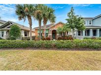 Charming house with pastel exterior, landscaping, and palm trees at 320 Winterside Dr, Apollo Beach, FL 33572