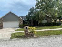 Single-story home with attached garage and well-maintained lawn at 809 Daphne Dr, Brandon, FL 33510