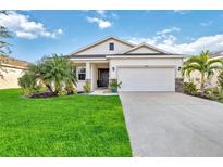 Curb appeal abounds in this charming one-story home, showcasing a well-manicured lawn and inviting facade at 3948 Mossy Limb Ct, Palmetto, FL 34221