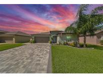 Attractive single-story house with a paved driveway and landscaping at 5429 Rainwood Meadows Dr, Apollo Beach, FL 33572