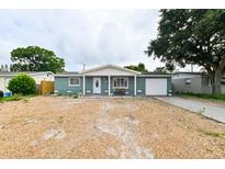 Ranch-style home with grey exterior, white trim, and a two-car garage at 3542 Connon Dr, New Port Richey, FL 34652