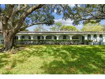 Exterior of a light blue building with a large tree and manicured lawn at 11200 102Nd Ave # 33, Seminole, FL 33778