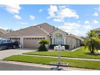 Attractive one-story home with a two-car garage and well-manicured lawn at 31932 Stillmeadow Dr, Wesley Chapel, FL 33543