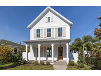 Two-story farmhouse with white siding, shutters, and a metal roof at 245 12Th Ne Ave, St Petersburg, FL 33701