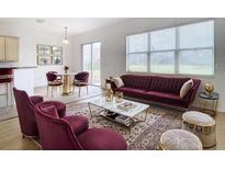 Elegant living room featuring a plush velvet sofa and tasteful decor at 10918 Ancient Futures Dr, Tampa, FL 33647