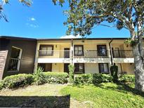 Condo building exterior, featuring balconies and landscaping at 3600 Magnolia Ridge Cir # 1221-G, Palm Harbor, FL 34684