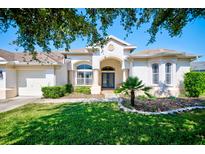 One-story home with attached garage, manicured lawn, and mature trees at 13267 Linzia Ln, Spring Hill, FL 34609