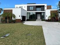 Modern two-story home with a large driveway and landscaped lawn at 1076 Snell Isle Ne Blvd, St Petersburg, FL 33704