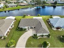 Single-story home with circular driveway and lake view at 2003 Wedge Ct, Sun City Center, FL 33573