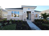 Single-story home with stone accents and landscaped walkway at 679 Allora Ave, Nokomis, FL 34275