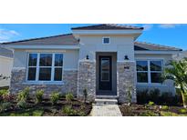 One-story home with stone accents and a landscaped front yard at 679 Allora Ave, Nokomis, FL 34275