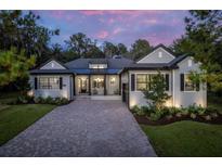 Stunning curb appeal! This two-story home boasts a charming front porch and landscaped yard at 4586 Hickory Oak Dr, Brooksville, FL 34601