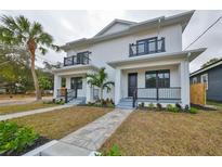 Modern two-story duplex with a walkway, landscaping, and two balconies at 1906 Cherry W St # 2, Tampa, FL 33607