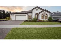 Two-story home with a three-car garage and landscaped front yard at 12823 Daleridge Pl, Riverview, FL 33579