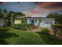 Charming mid-century home with landscaped lawn and updated facade at 5101 W Platt St, Tampa, FL 33609