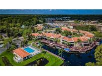 Aerial view of waterfront community with pool and boat docks at 2571 Cyprus Dr # 1-202, Palm Harbor, FL 34684