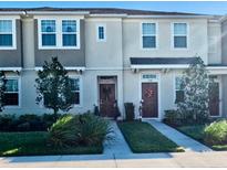 Two-story townhome with front yard and landscaping at 11712 Stonesmith Xing, Palmetto, FL 34221