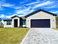 New single-Gathering home with a two-car garage and a paved driveway at 12152 Snow Bird Ave, Port Charlotte, FL 33981