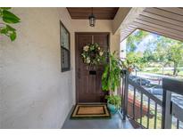 Inviting condo entry with a wreath and potted plants at 3505 Tarpon Woods Blvd # K409, Palm Harbor, FL 34685