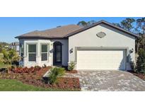 Single-story home with a two-car garage and landscaped front yard at 9457 Barnacle Ln, Parrish, FL 34219