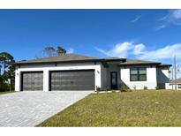 New construction home with three-car garage and attractive landscaping at 12140 Warden Ave, Port Charlotte, FL 33981