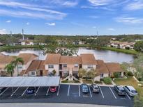 Aerial view showcasing condo community by a lake at 3840 Staysail Ln # 3840, Holiday, FL 34691