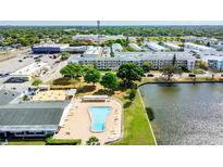 Aerial view of community with pool, lake, and buildings at 5875 21St N St # 15L, St Petersburg, FL 33714