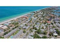 A beautiful aerial view shows the property's proximity to the beach with stunning turquoise ocean waters at 2109 Gulf Blvd # 1B, Indian Rocks Beach, FL 33785